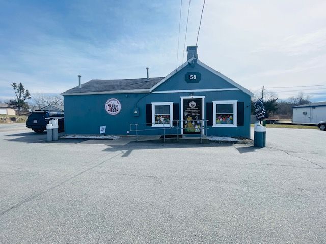 A small blue building with a sign that says ' ambulance ' on it
