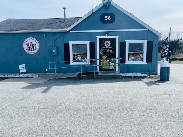 A blue building with a handicap ramp in front of it.