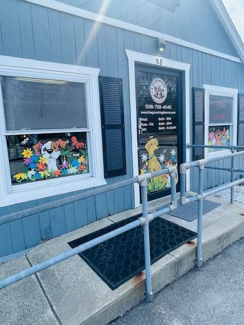A blue building with a ramp leading to the door