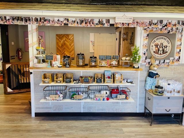A store front with a counter and shelves filled with lots of items.