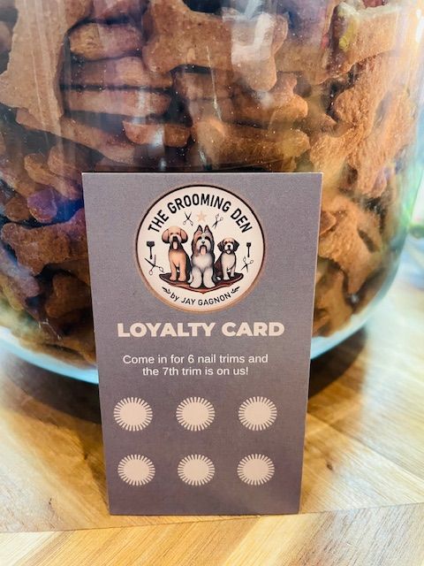 A loyalty card is sitting in front of a jar of dog treats