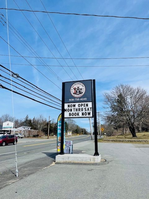 A sign that says now open mon thurs sat book now