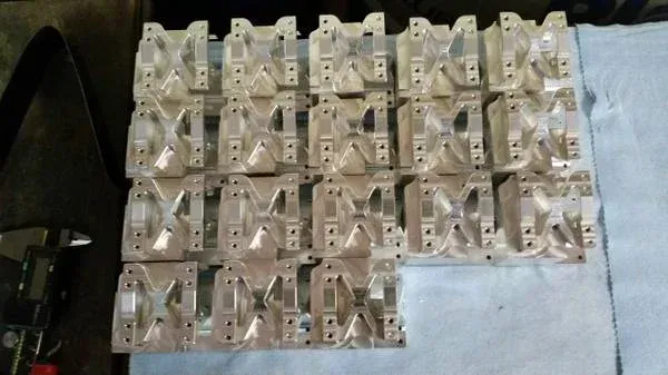 A vacuum cleaner is cleaning a carpet in a library.