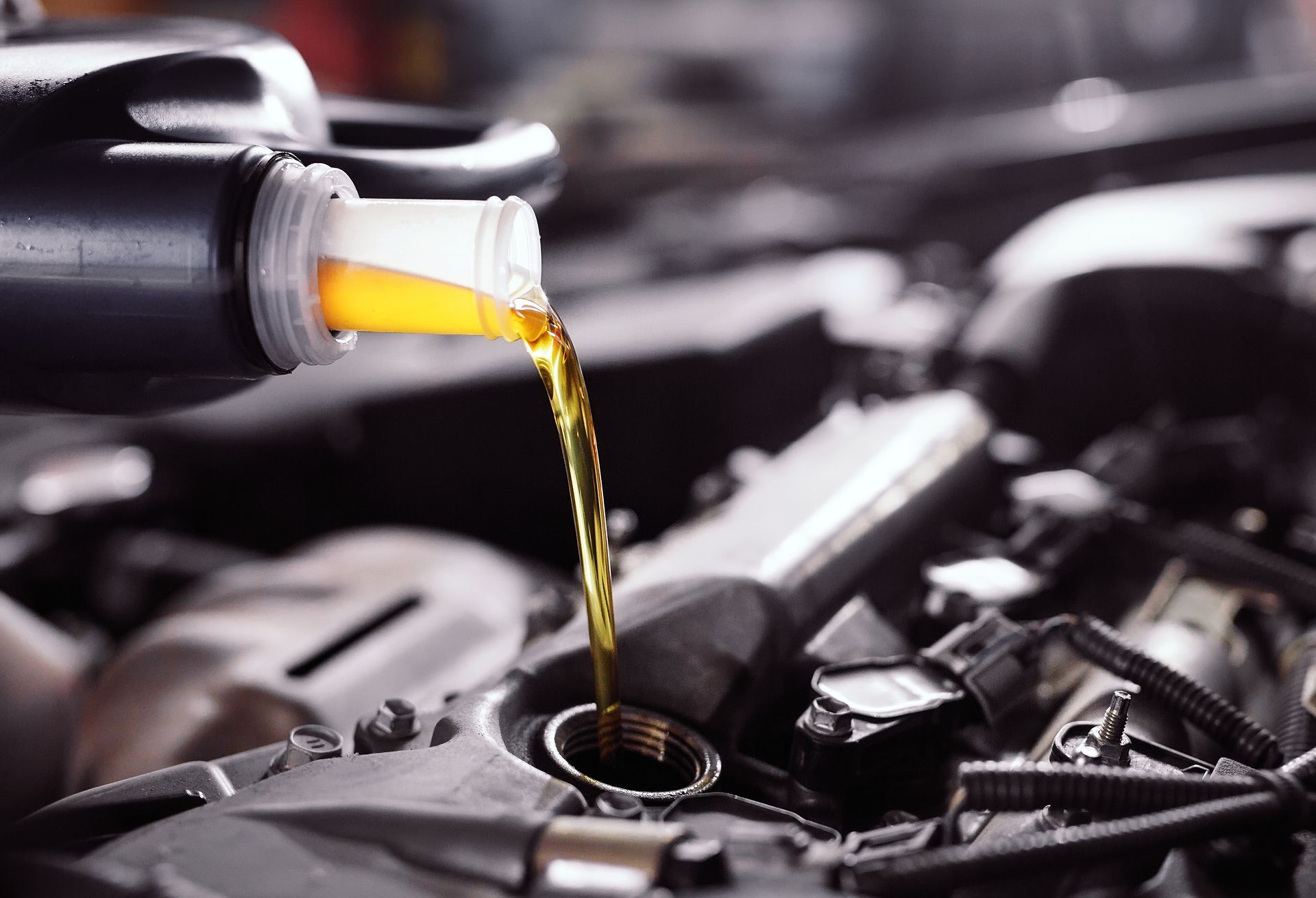 Oil pouring into a car engine during maintenance | Ron's Auto & RV