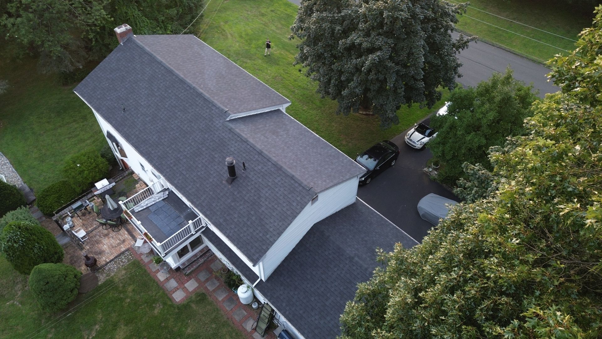 An aerial view of a house with a car parked in front of it.