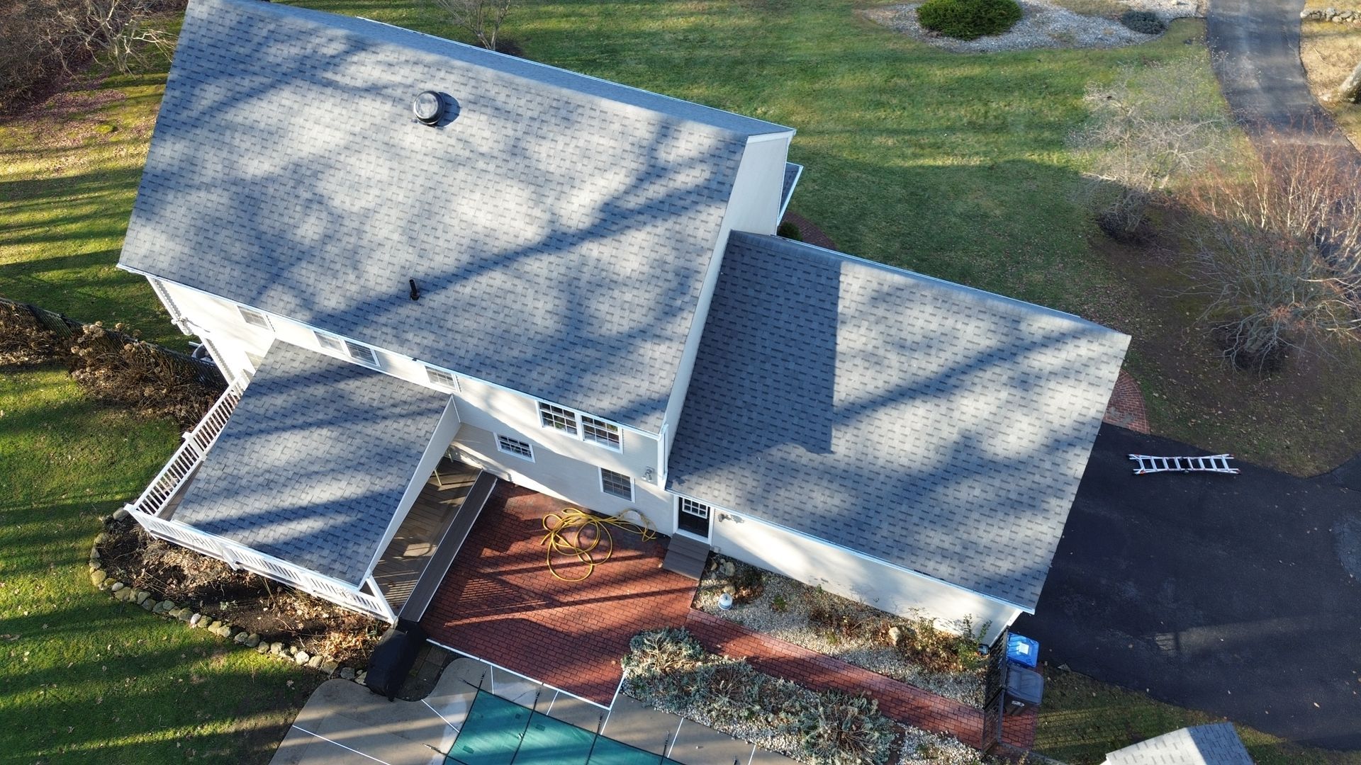 An aerial view of a house with a gray roof
