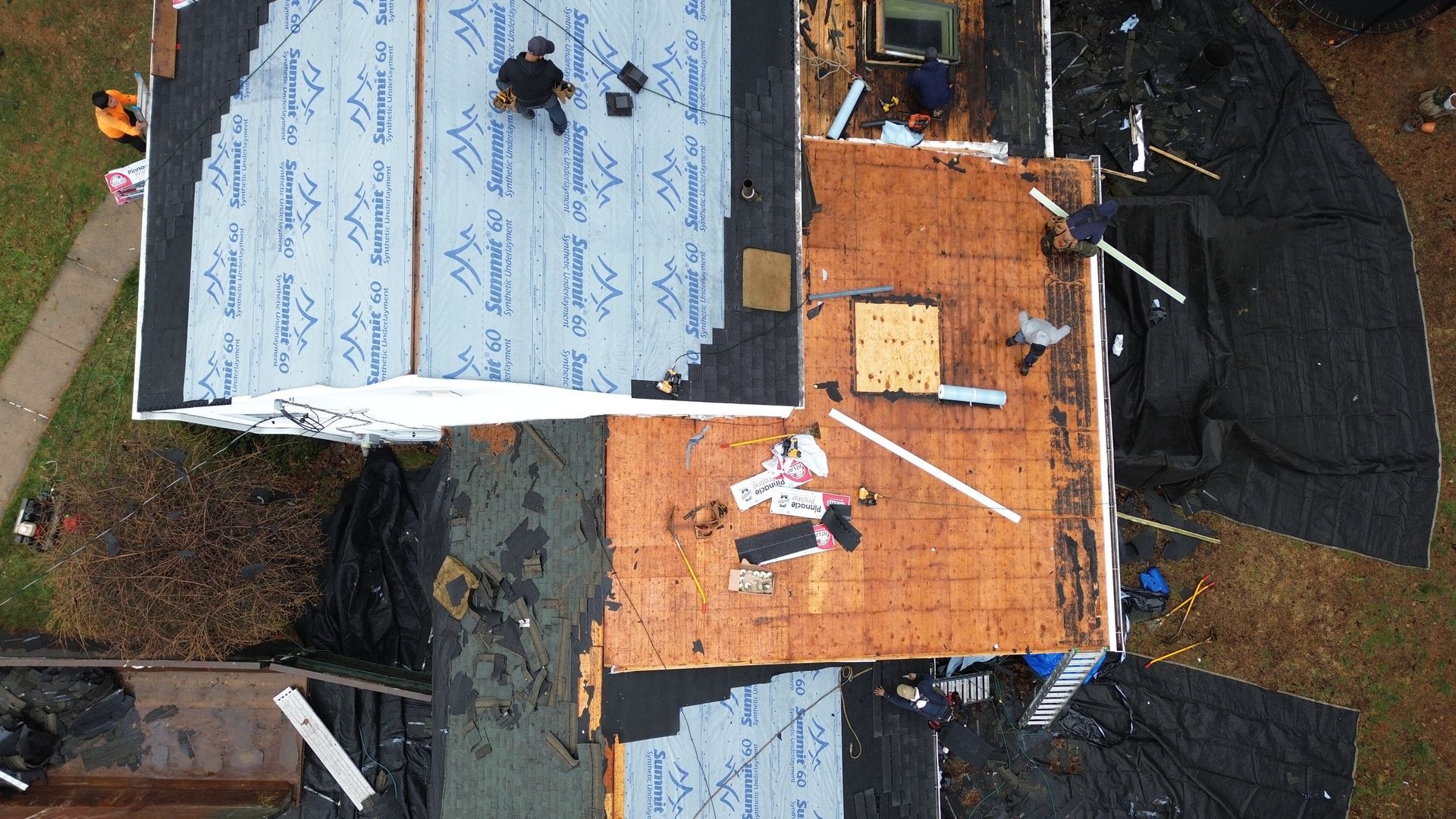 An aerial view of a roof being installed on a house