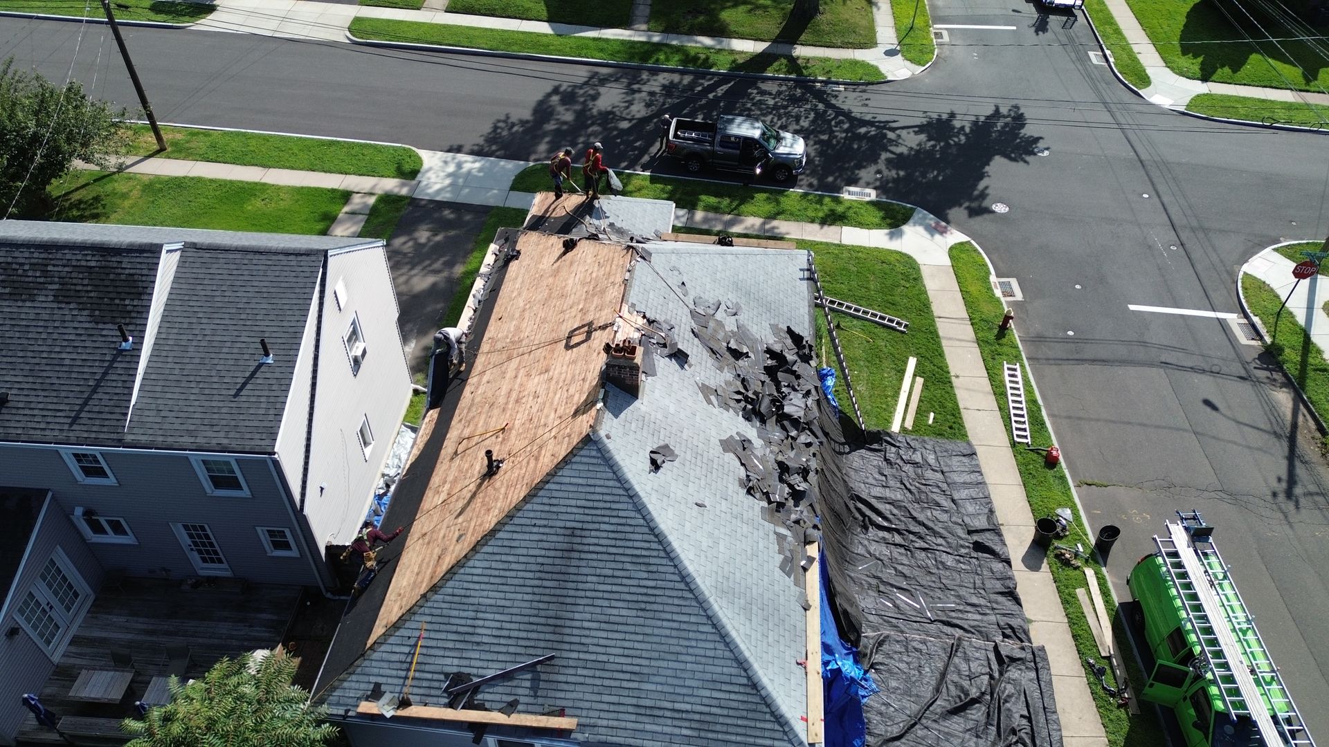 An aerial view of a roof being installed on a house.