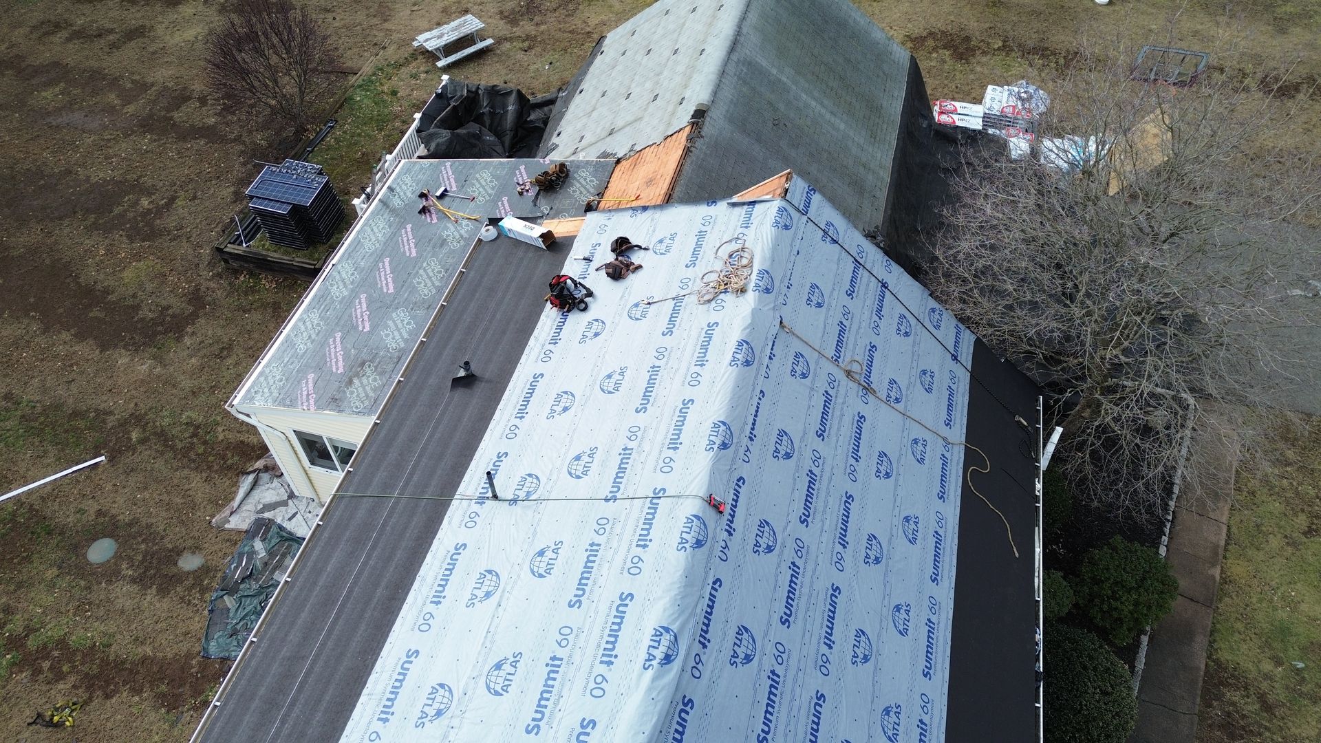 An aerial view of a house with a roof being installed.