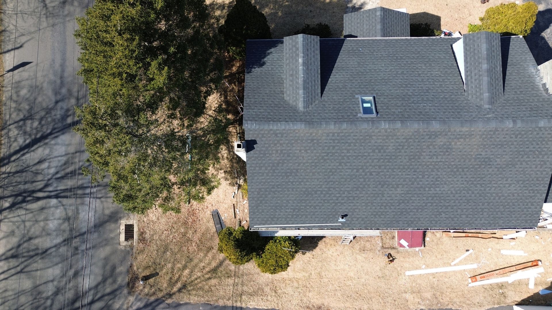 An aerial view of a house with a skylight on the roof.