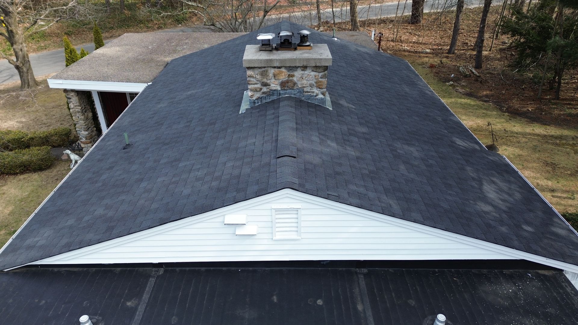 The roof of a house with a chimney on top of it.
