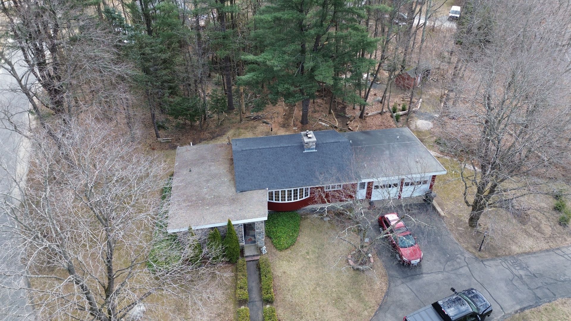 An aerial view of a house with a car parked in front of it.