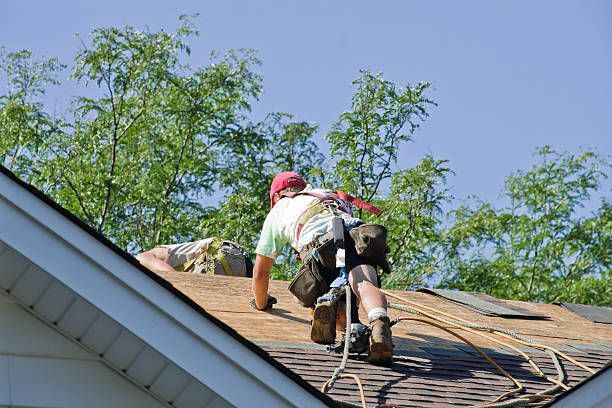 A man is working on the roof of a house.