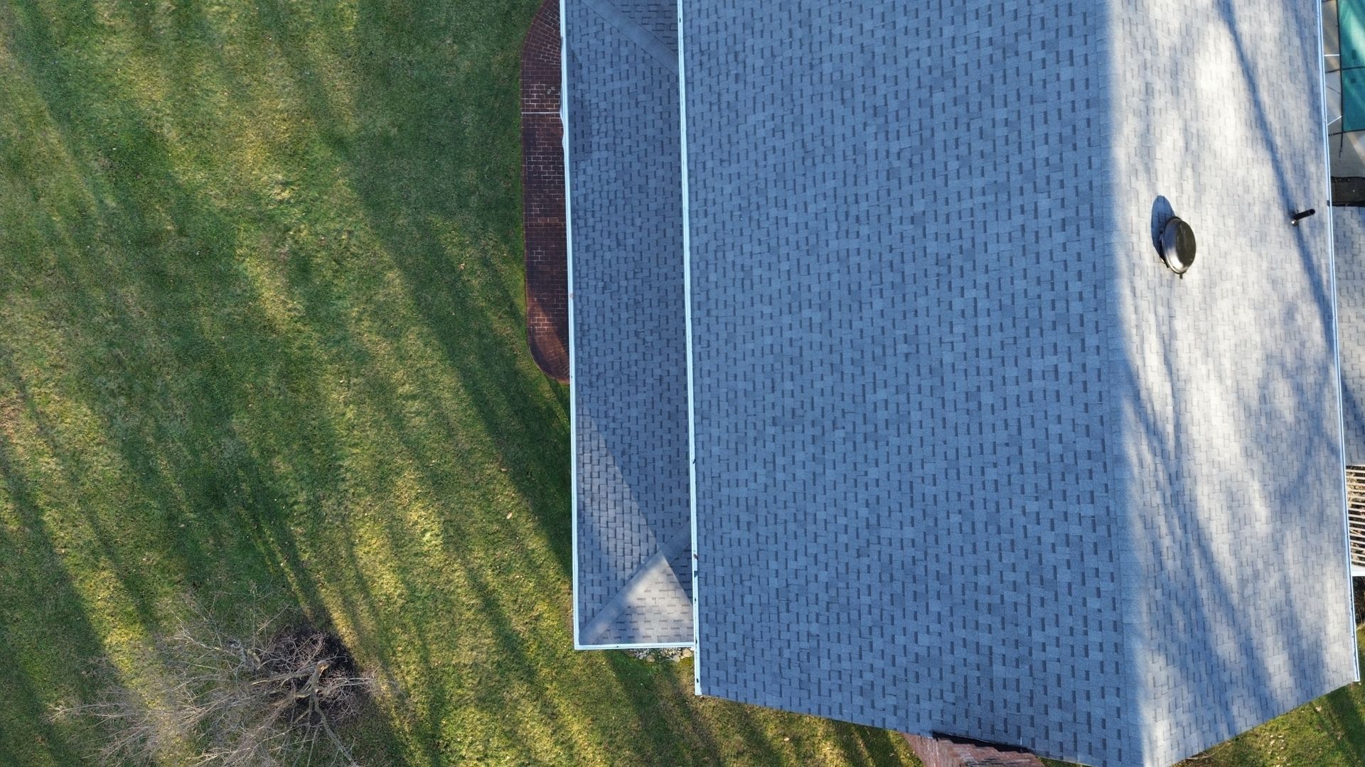 An aerial view of a picnic table in a grassy field.