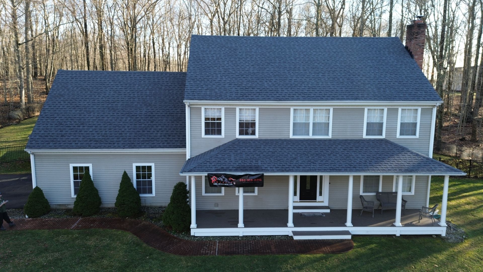 A large house with a blue roof and a porch