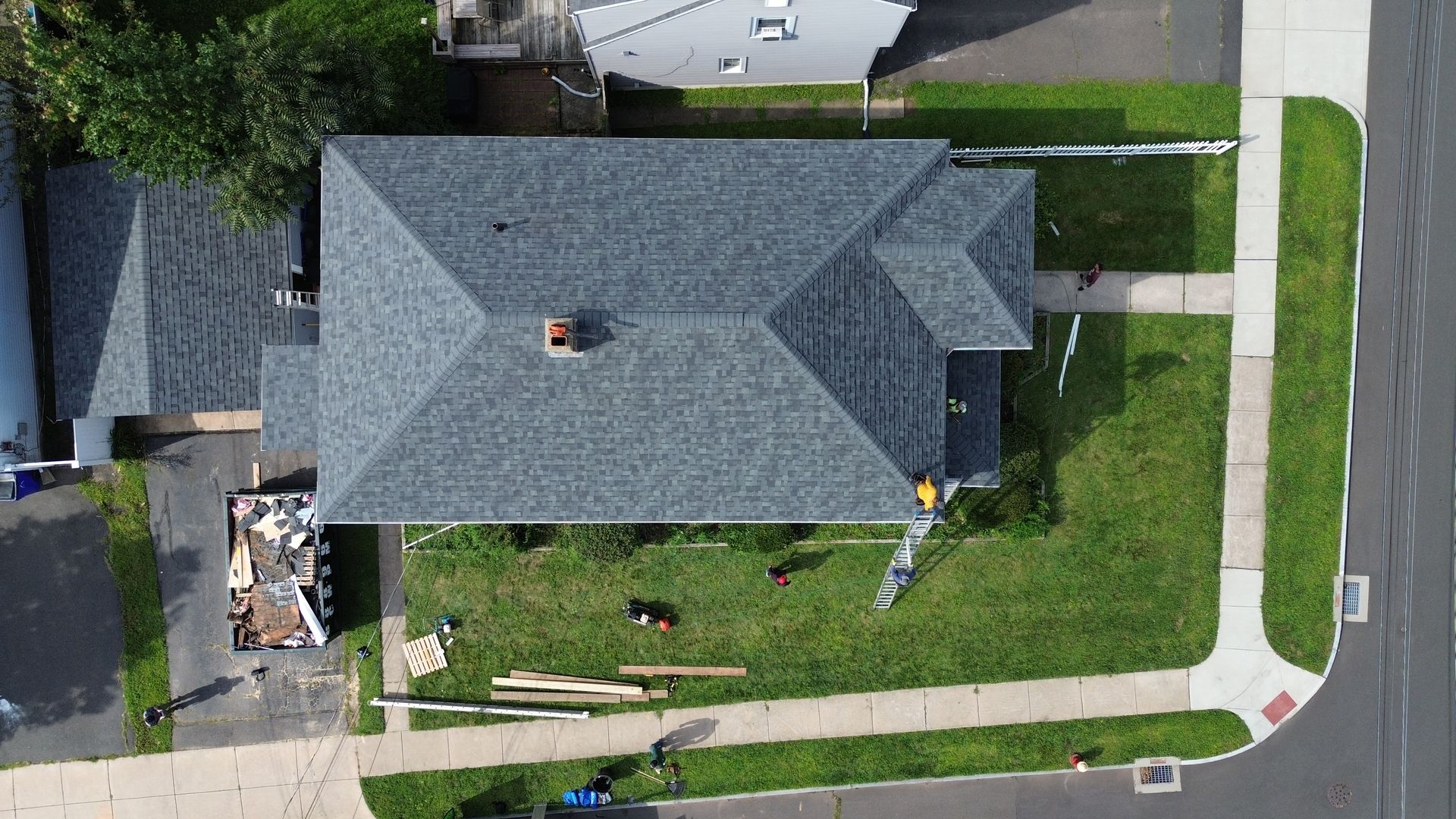 An aerial view of a house with a roof that is being repaired.