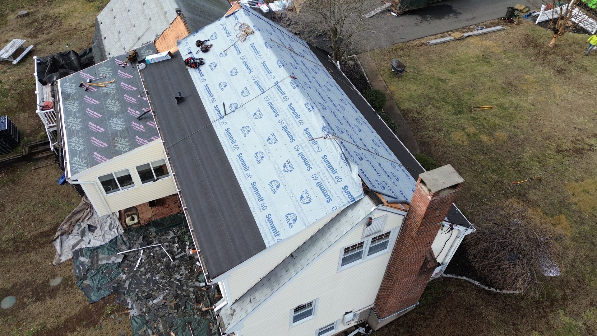 An aerial view of a house being remodeled with a new roof.