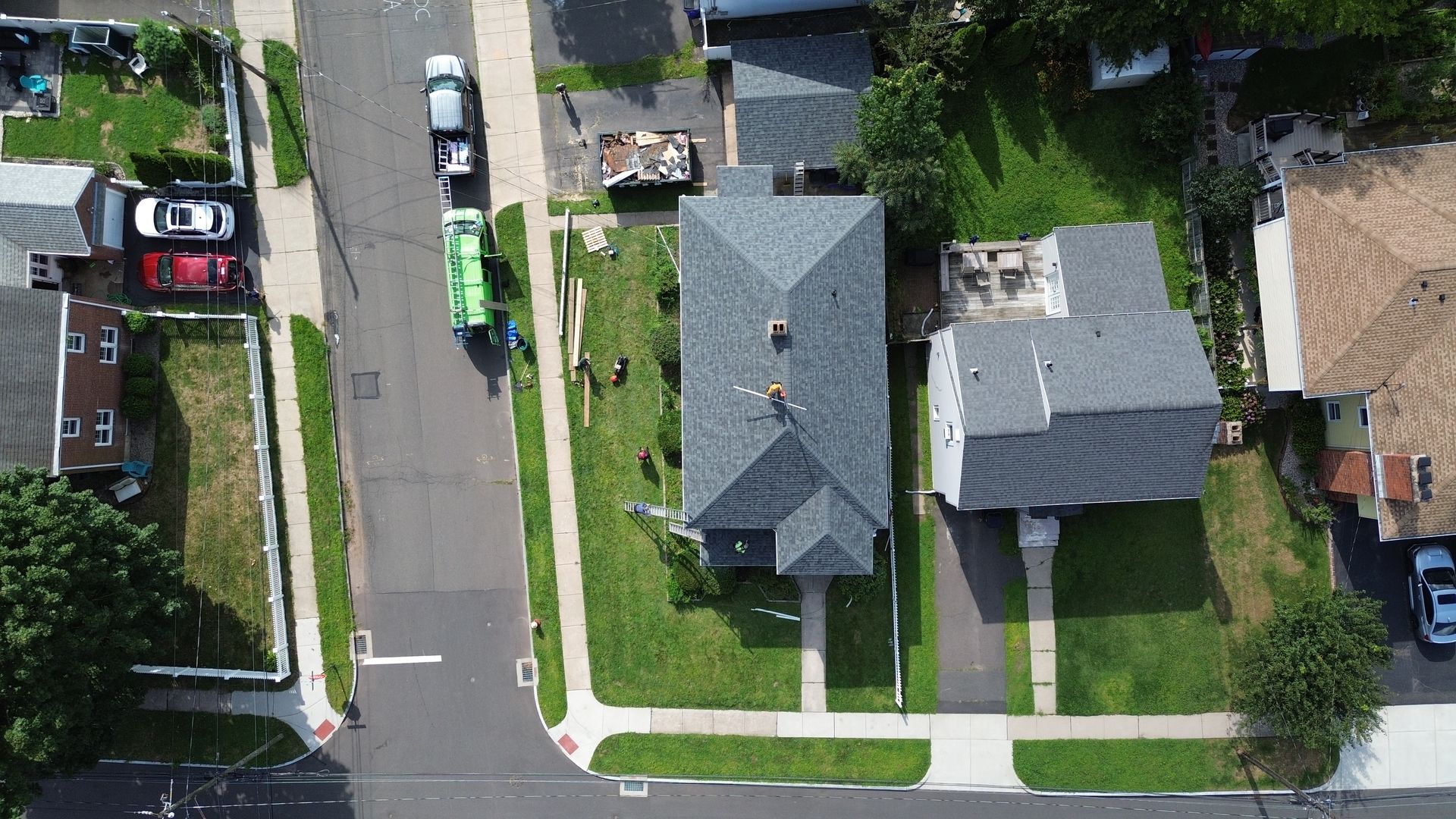 An aerial view of a residential neighborhood with houses and a street.