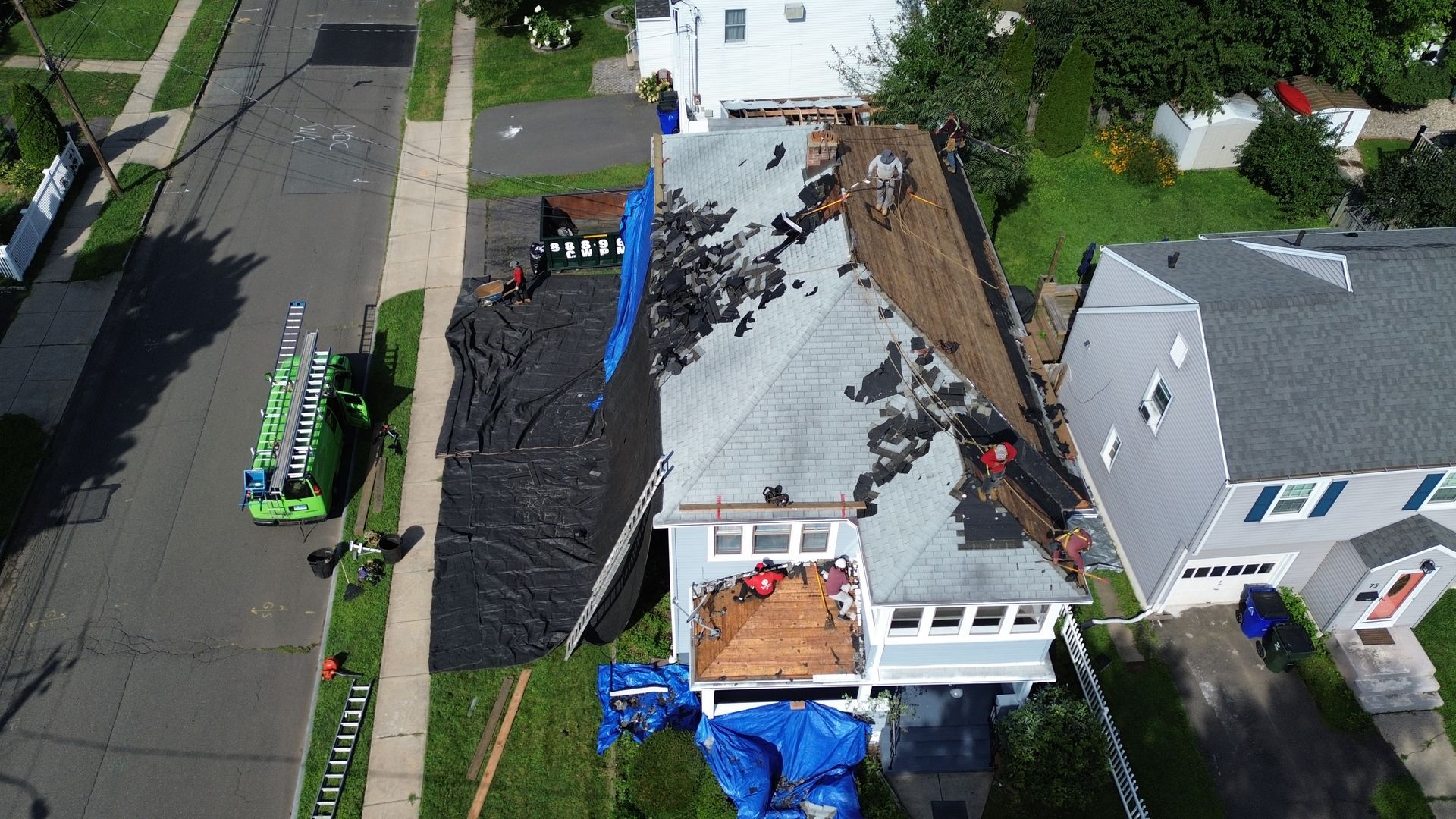 An aerial view of a roof being installed on a house.