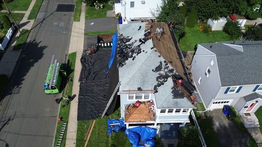 An aerial view of a roof being installed on a house.