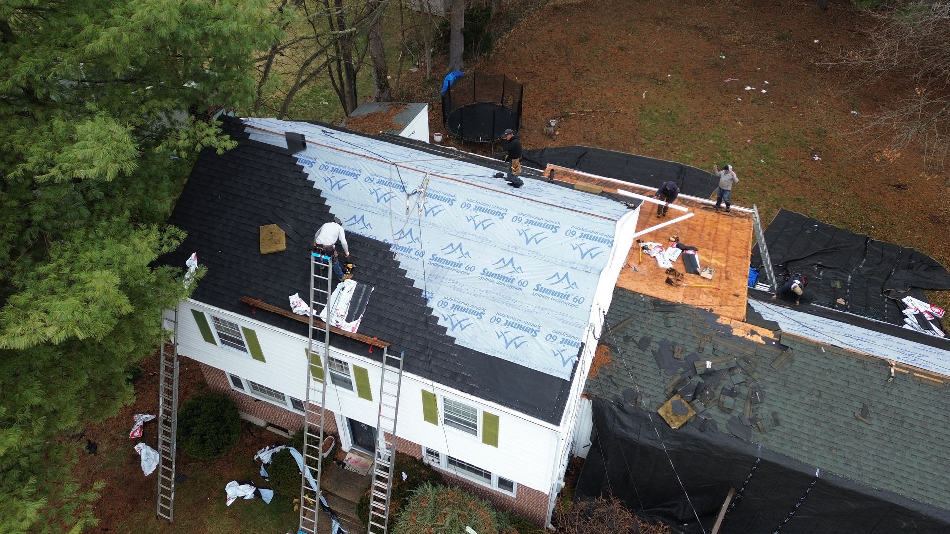 An aerial view of a roof being installed on a house.