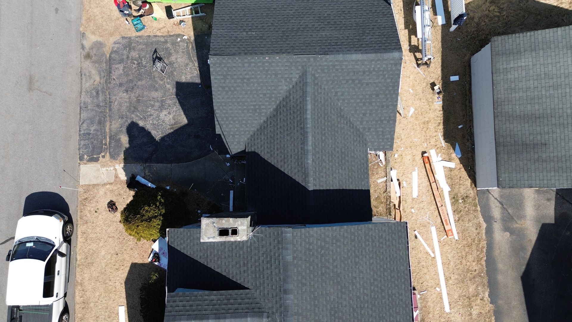 An aerial view of a house with a white truck parked in front of it.