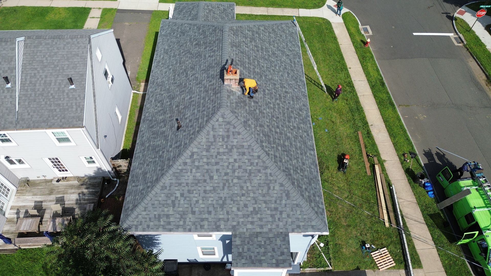 An aerial view of a house with a new roof being installed.