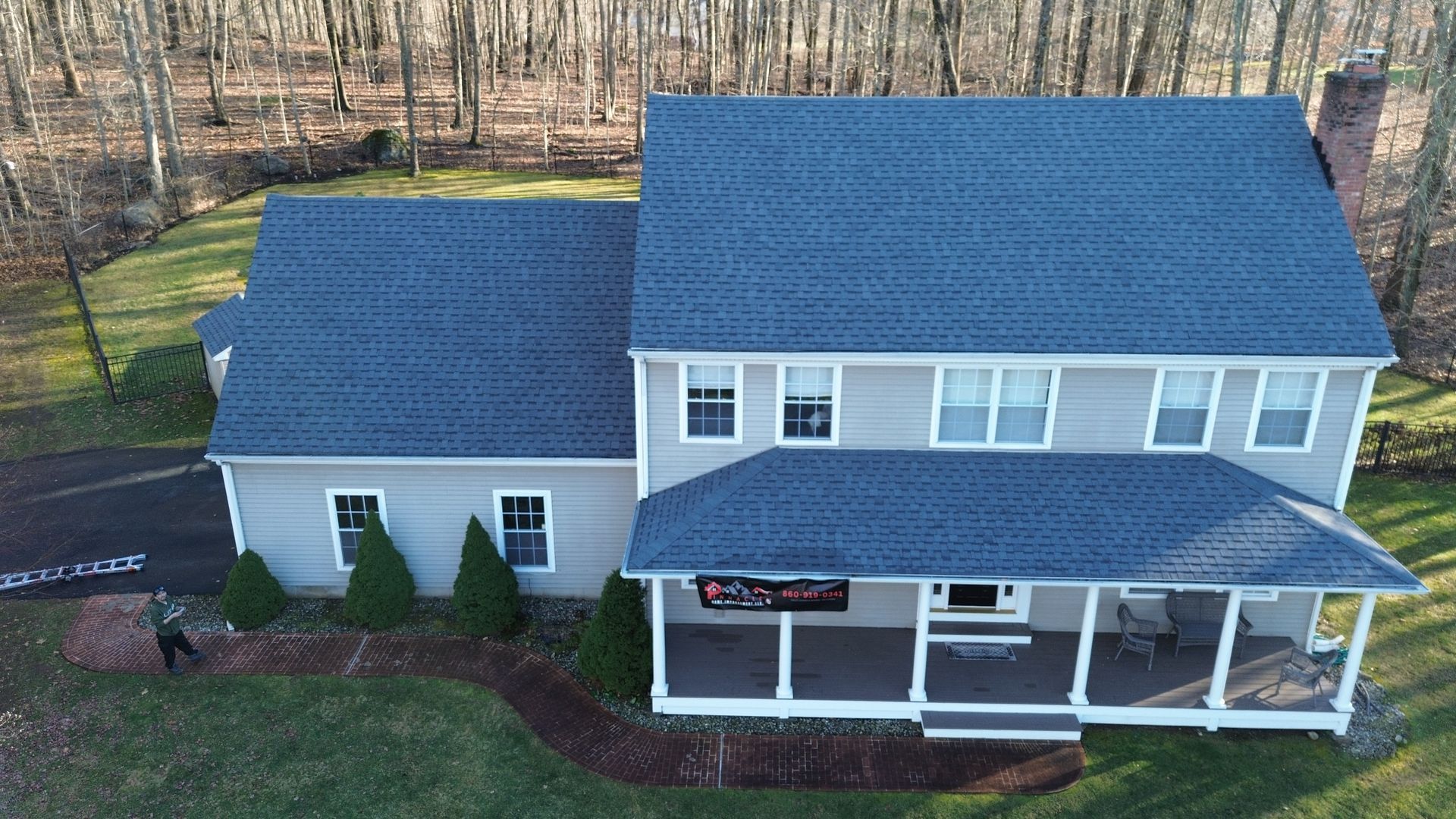 An aerial view of a house with a blue roof