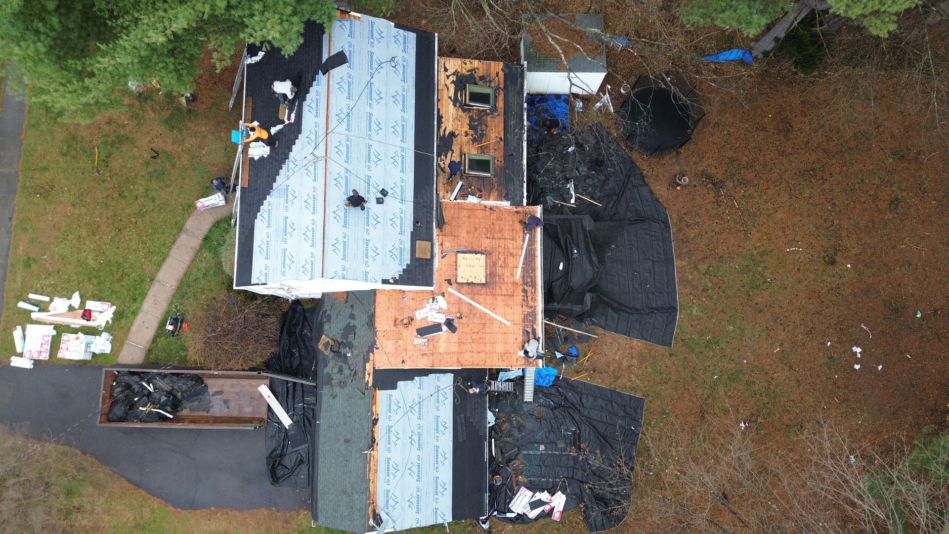 An aerial view of a house being remodeled with a new roof.