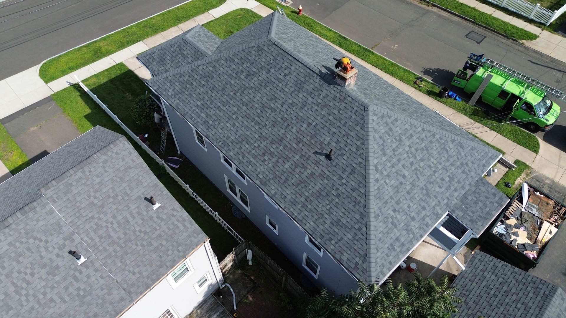 An aerial view of a house with a roof being installed.