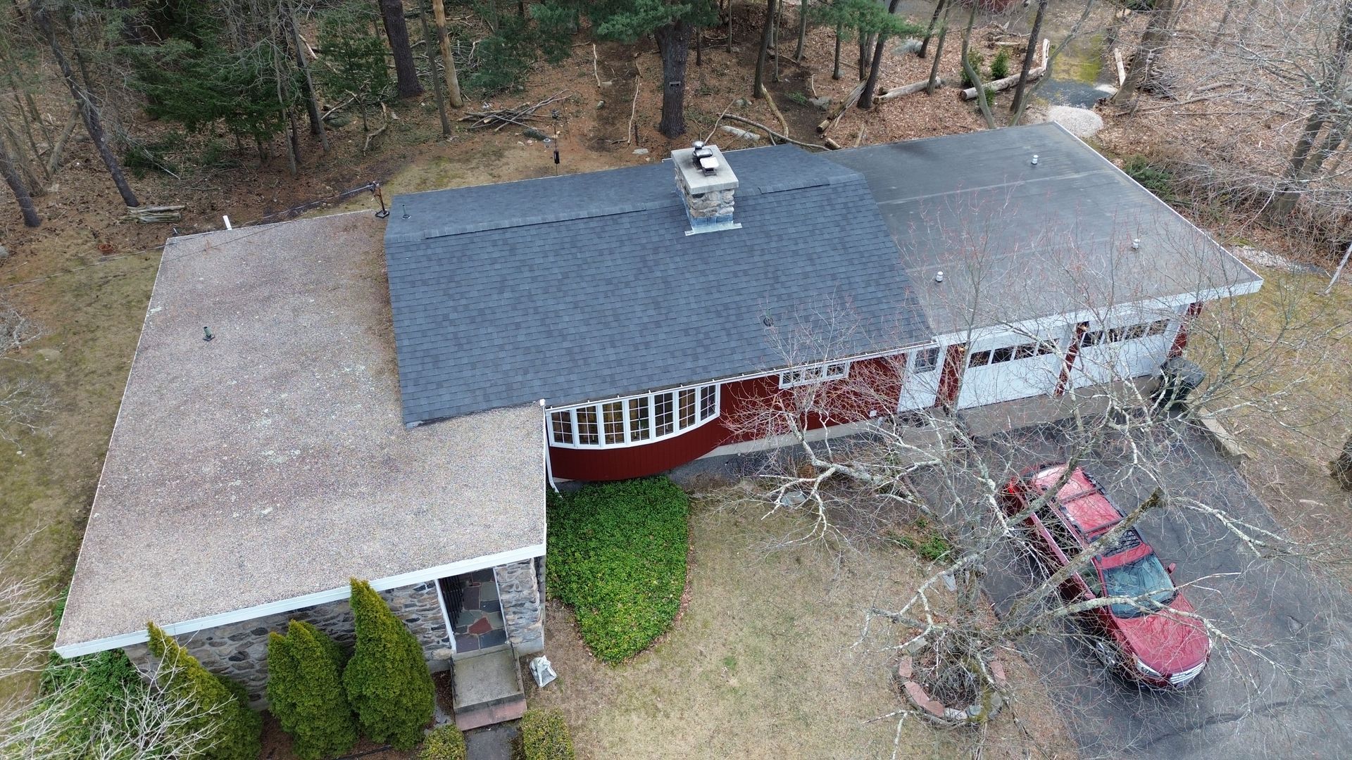 An aerial view of a house with a red truck parked in front of it.
