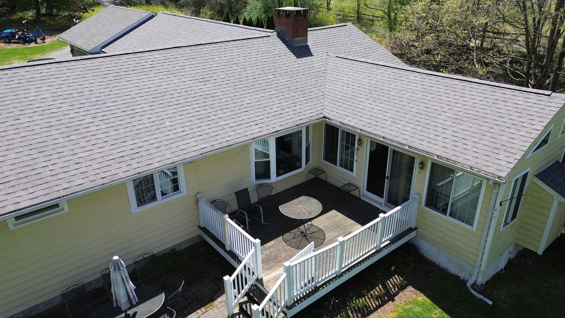 An aerial view of a house with a large deck.