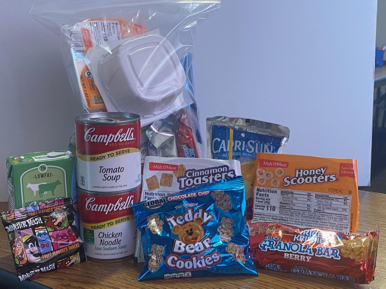 Food items On A Desk - Soup, Milk, Capri Sun, Fruit Snacks, and other various items