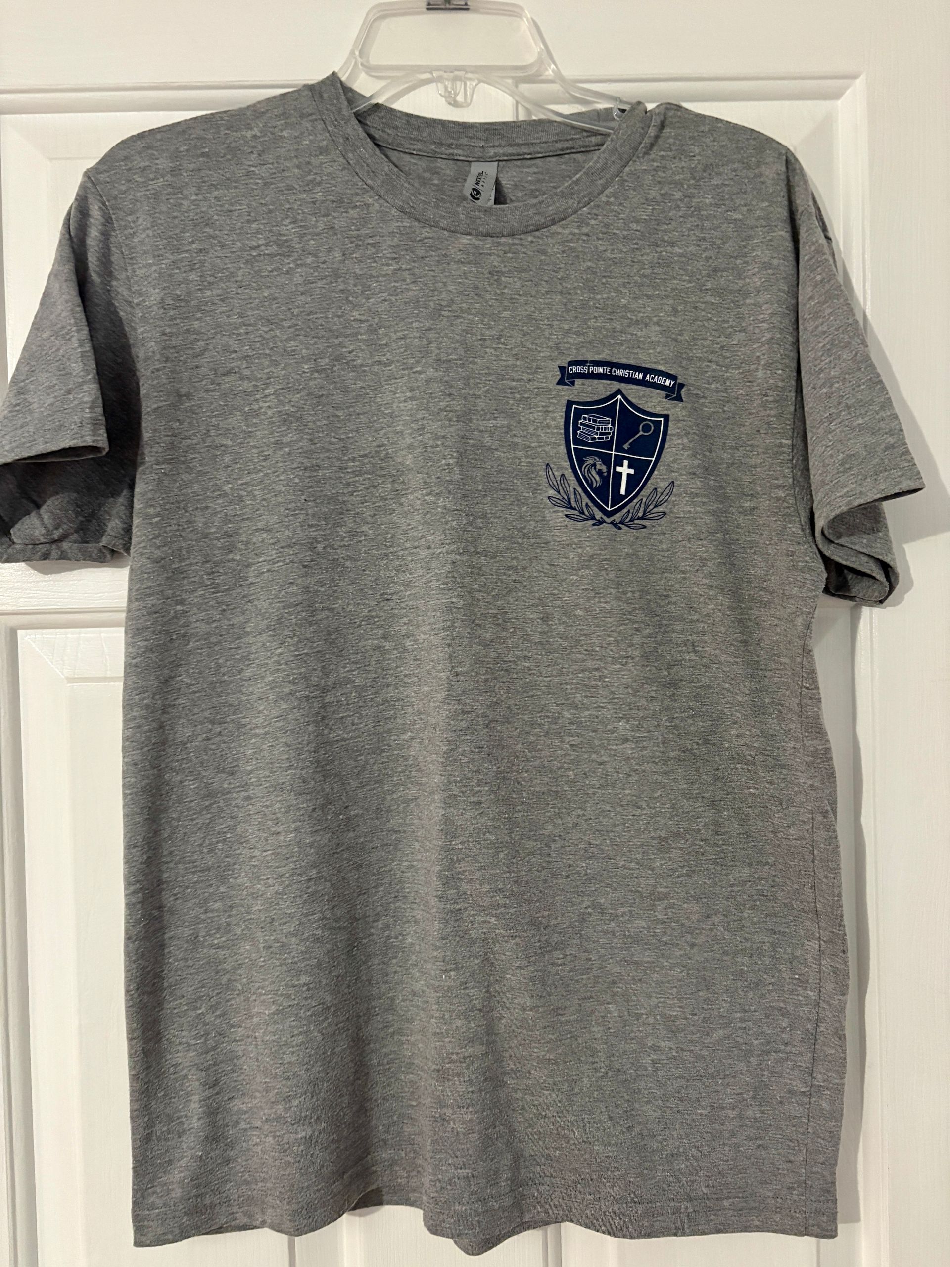 Gray t-shirt with a blue shield design on the chest.