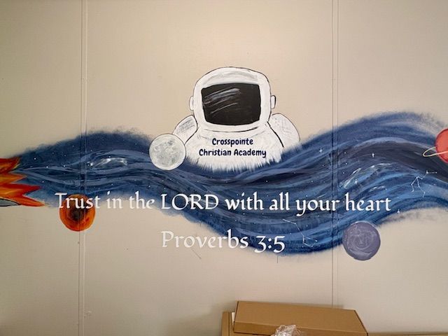 Mural with an astronaut, planets, and text