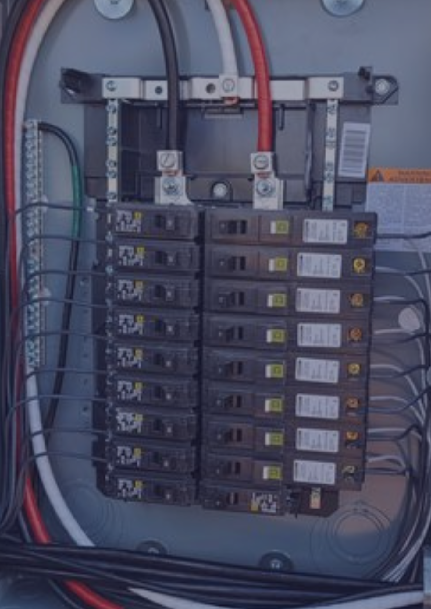 A close up of a electrical panel with a bunch of wires coming out of it