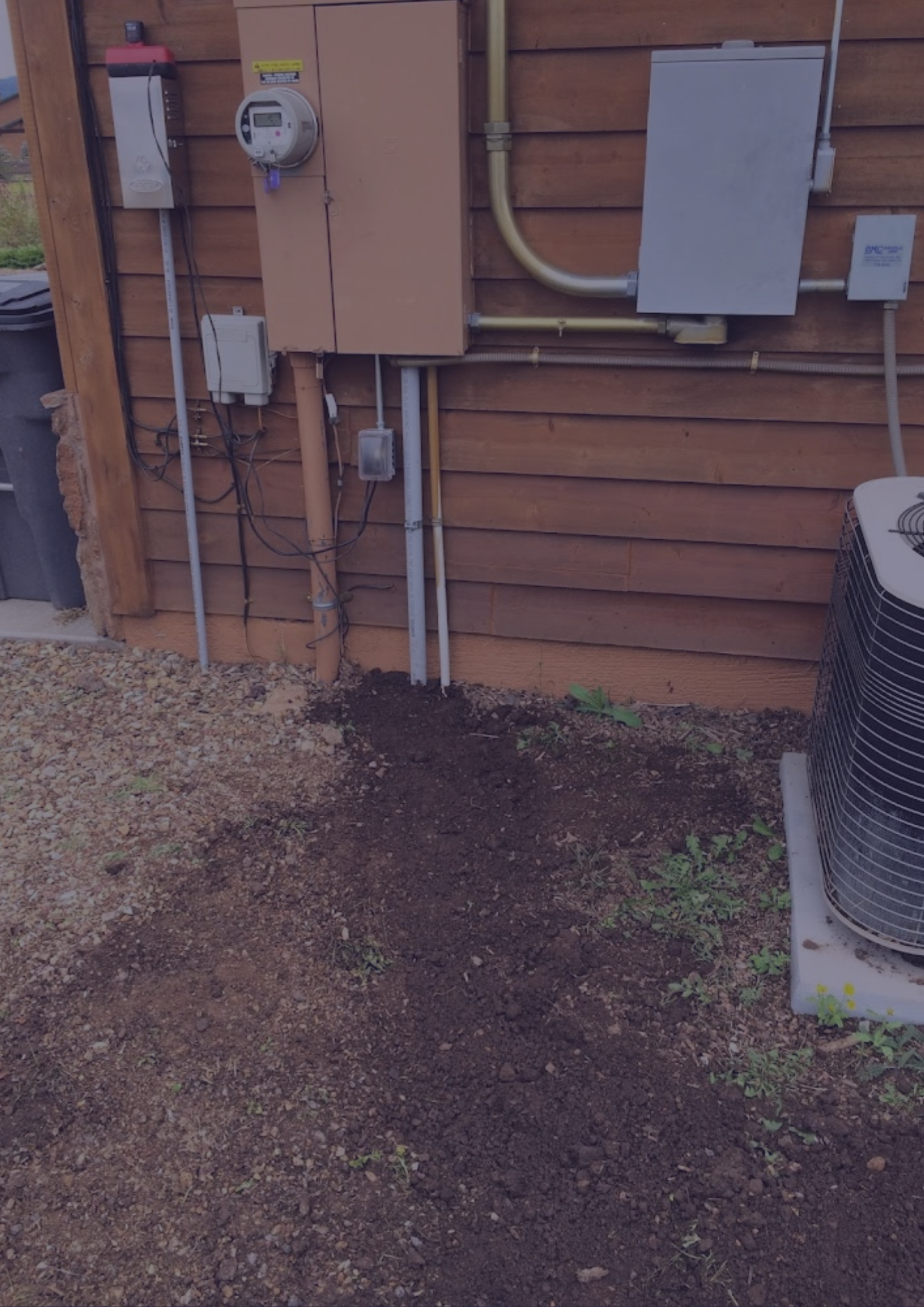 A house with a lot of electrical wires on the side of it
