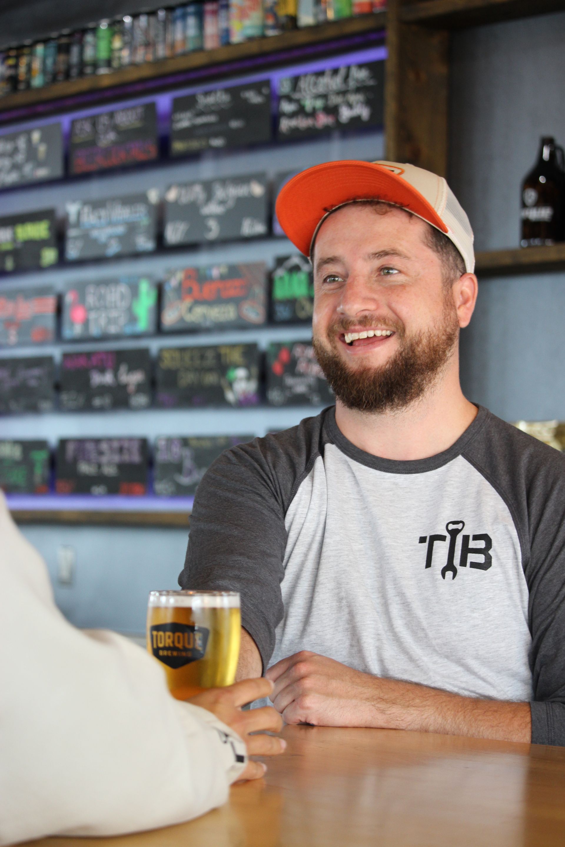 A person wearing a hoodie that says torque brewing