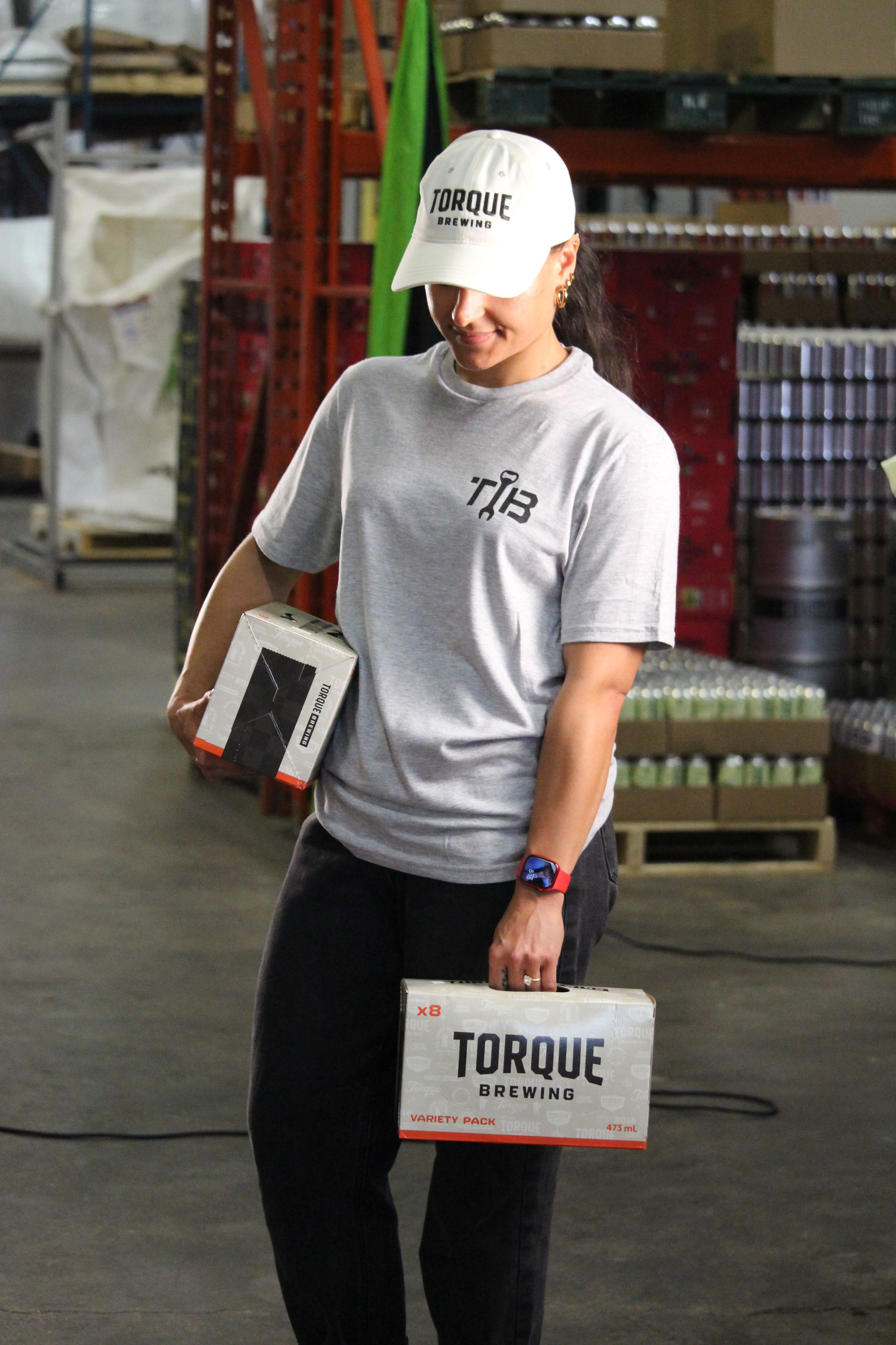 A person wearing a hoodie that says torque brewing