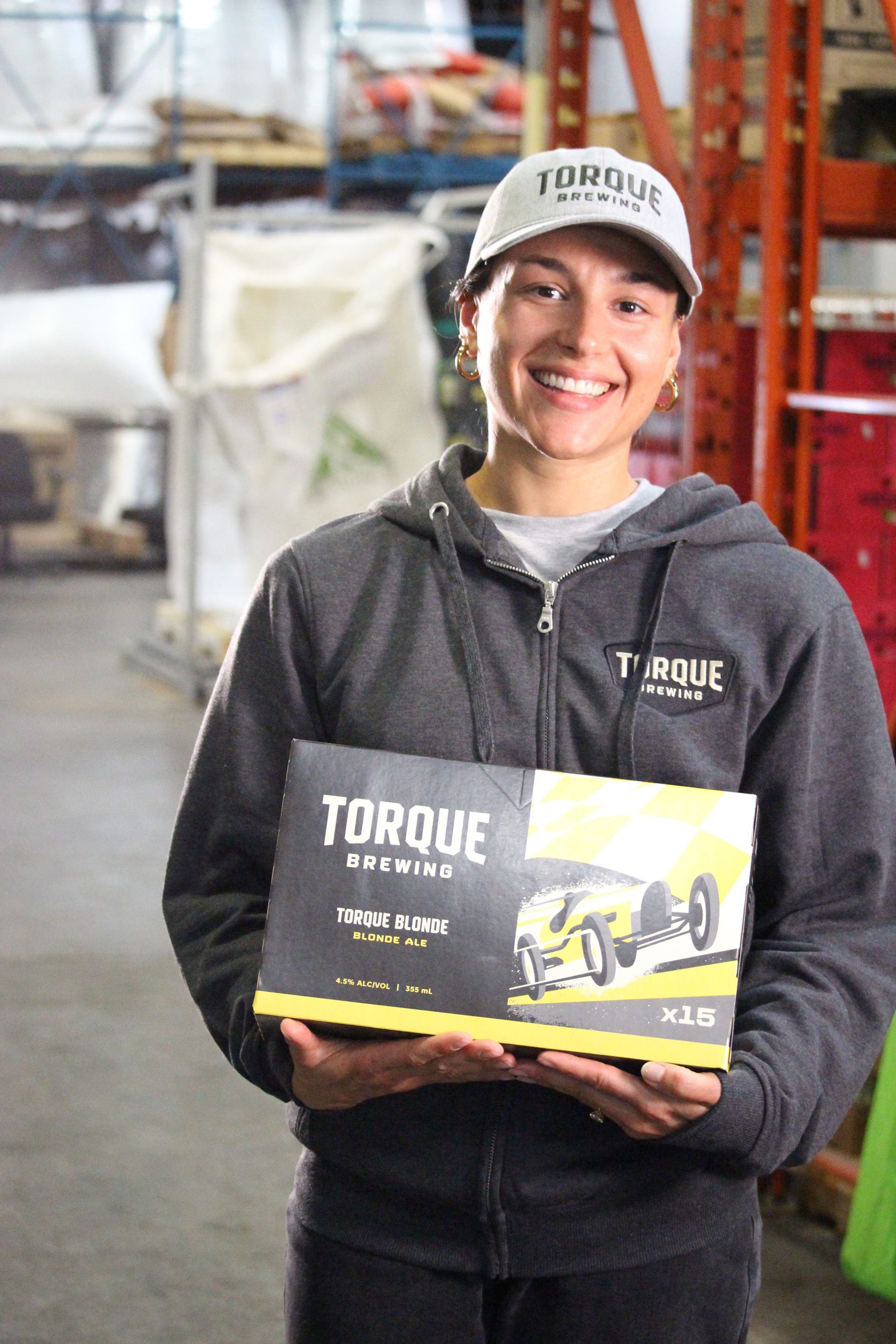 A person wearing a hoodie that says torque brewing