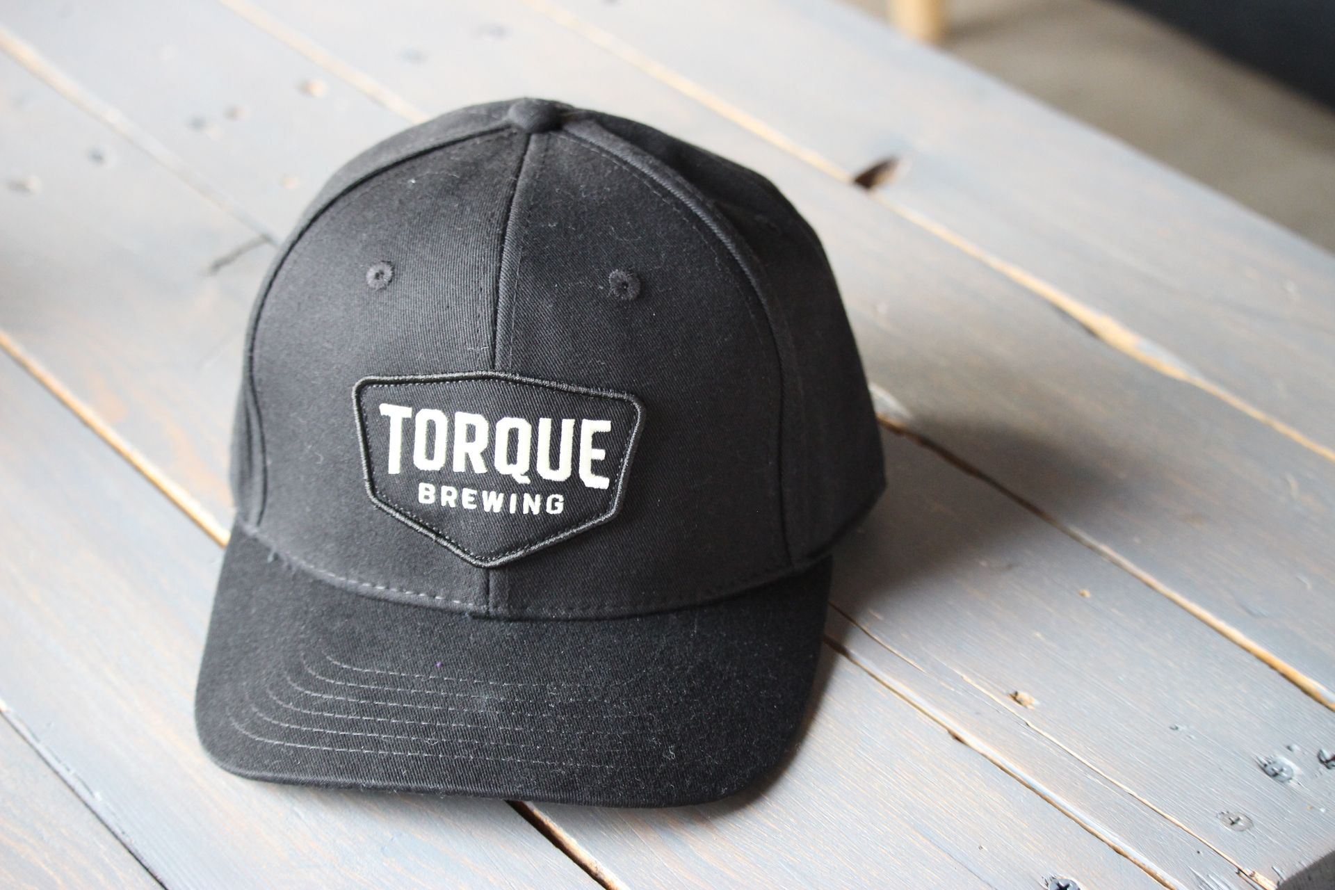 A person wearing a hoodie that says torque brewing