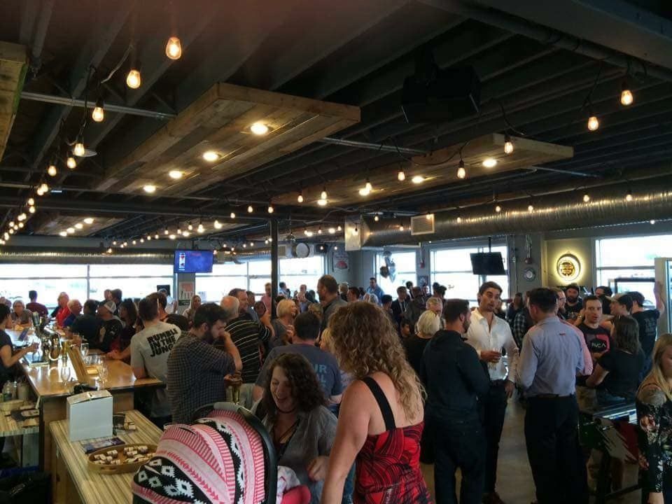 A large group of people are gathered in a large room.