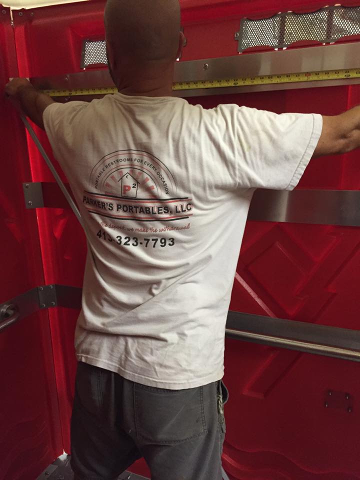 Man Measuring The Portable Toilet — Belchertown, MA — Parker’s Portables LLC