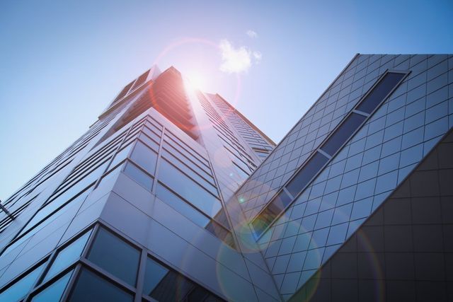 The sun is shining through the windows of a tall building.