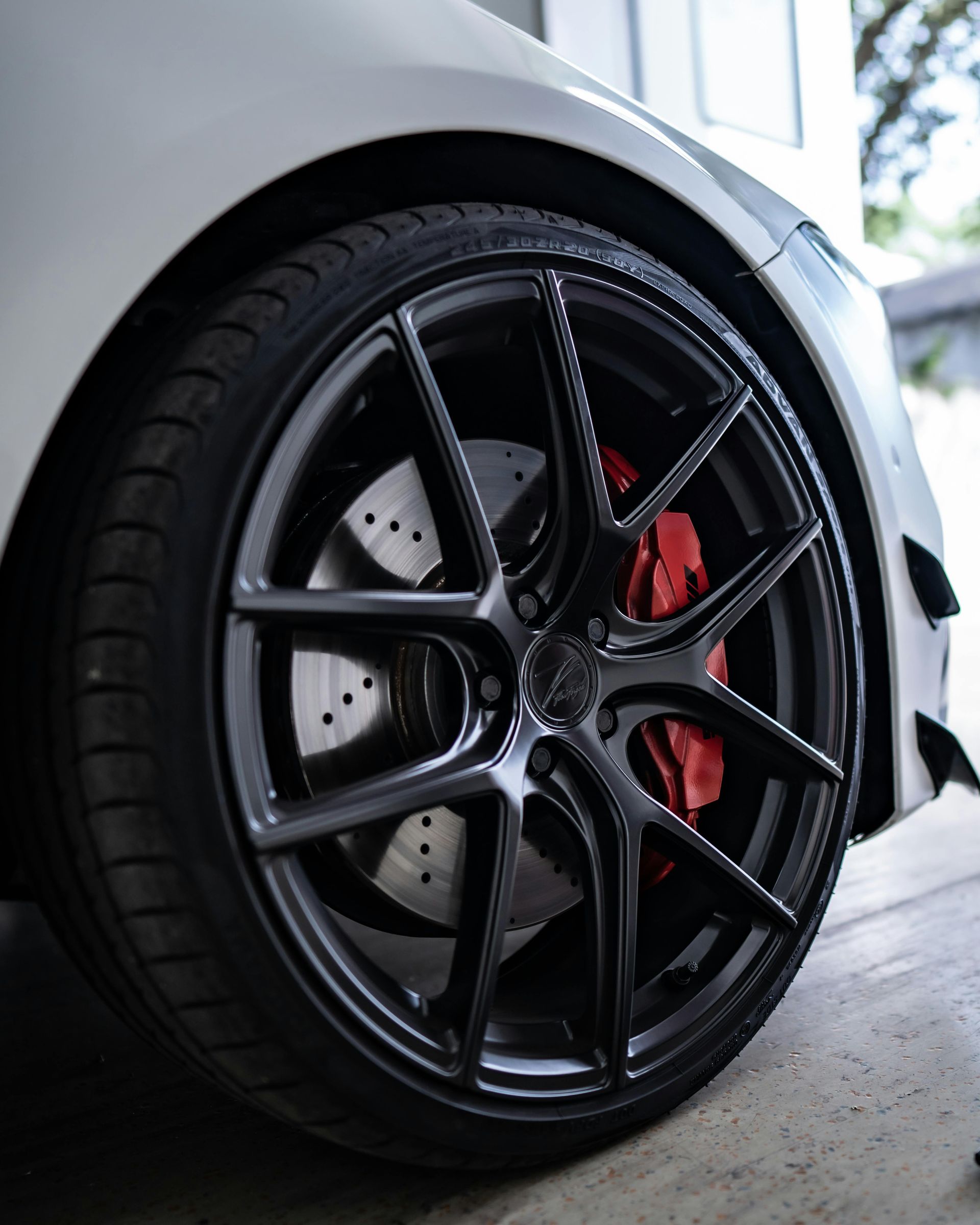 A close up of a brake disc and brake caliper on a car.