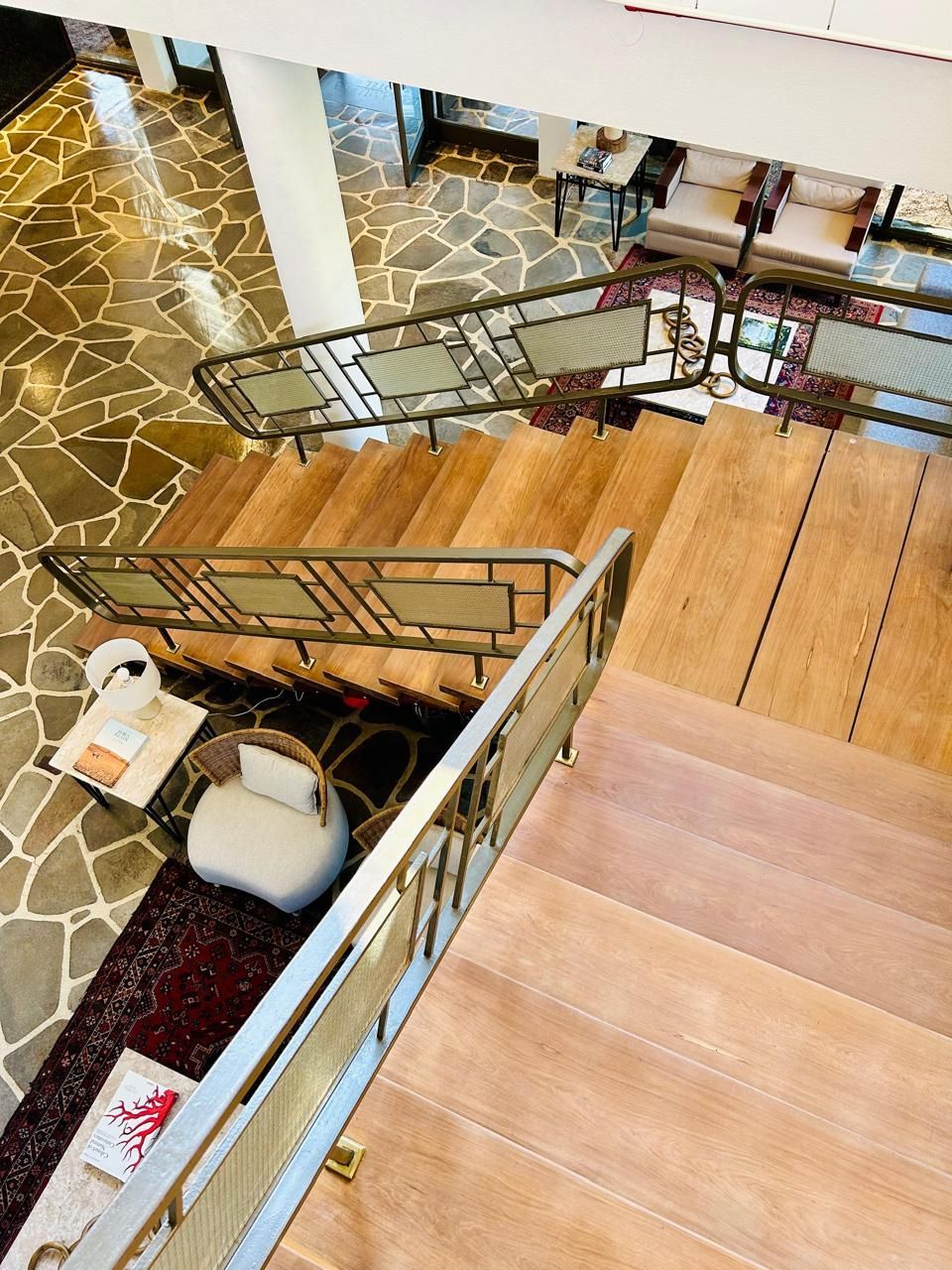 Uma vista aérea de uma escada de madeira com corrimão de metal