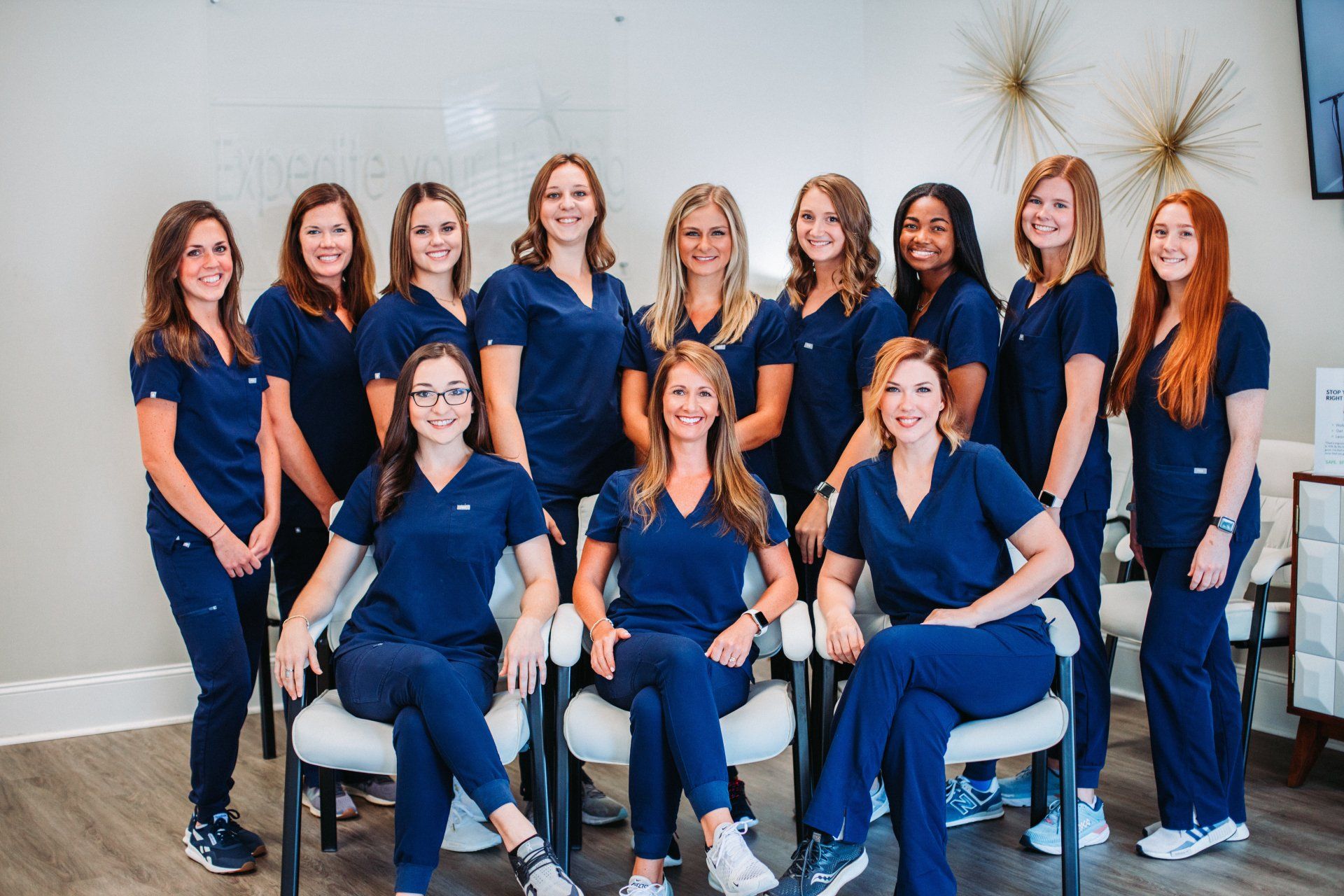 A group of women in scrubs are posing for a picture.