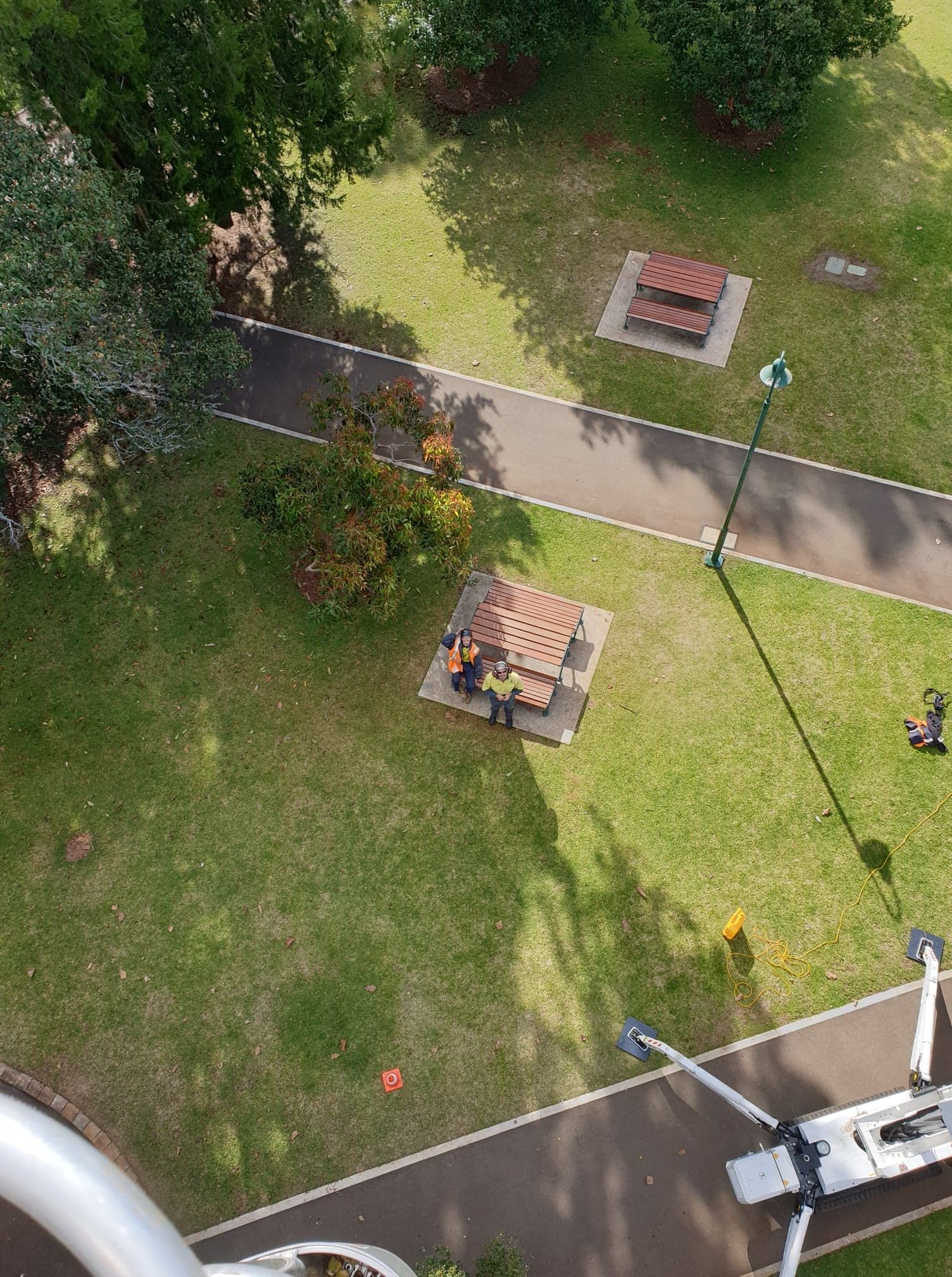 An aerial view of a park with a picnic table in the middle of it.