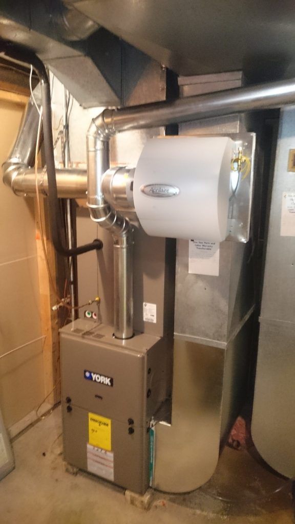 York furnace with attached humidifier in a basement setting.