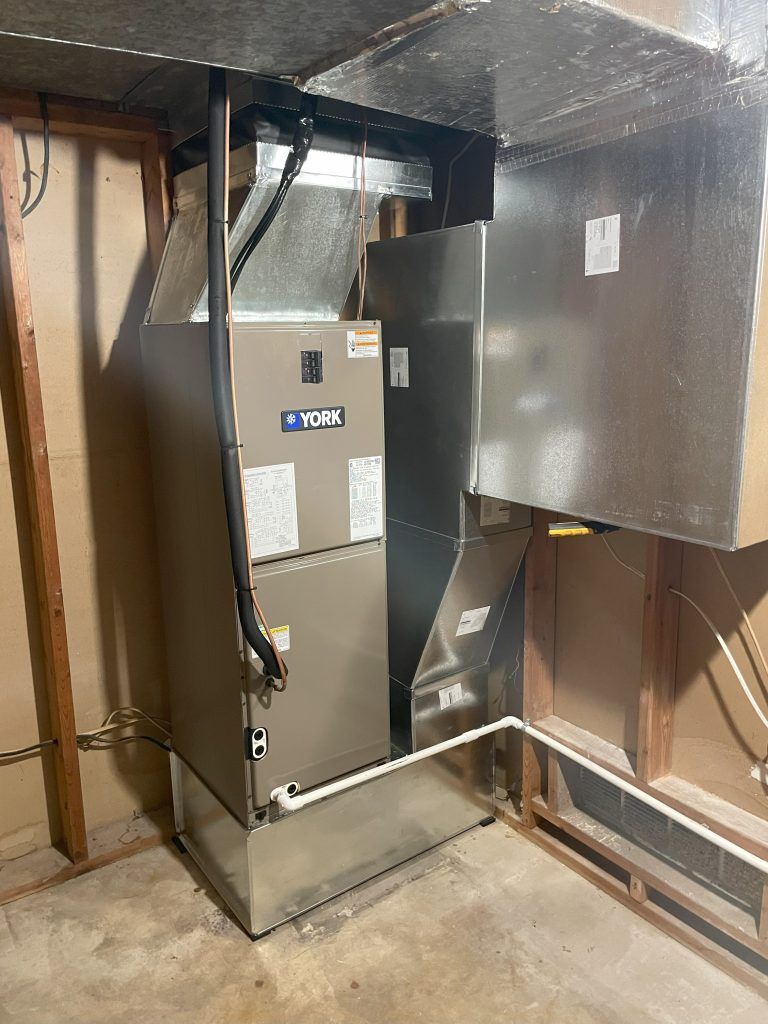 A York furnace with ductwork in a basement setting.